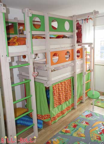 A Both-Up Bunk Bed Type 2B. Our customers ordered the porthole theme boards, ladder rungs and handles with green and orange varnish. The curtains, which have been attached around the play den underneath the lower sleeping level, match them perfectly in colour.