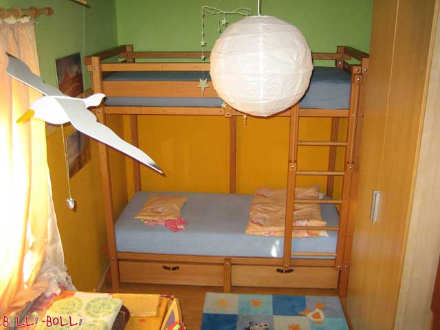 The depicted Youth Bunk Bed is made of oil-waxed beech and has two bed drawers. (Youth Bunk Bed)